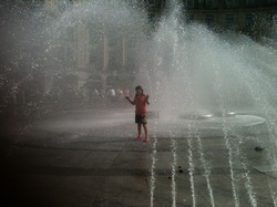 Granddaughter having fun in a fountain in Munich