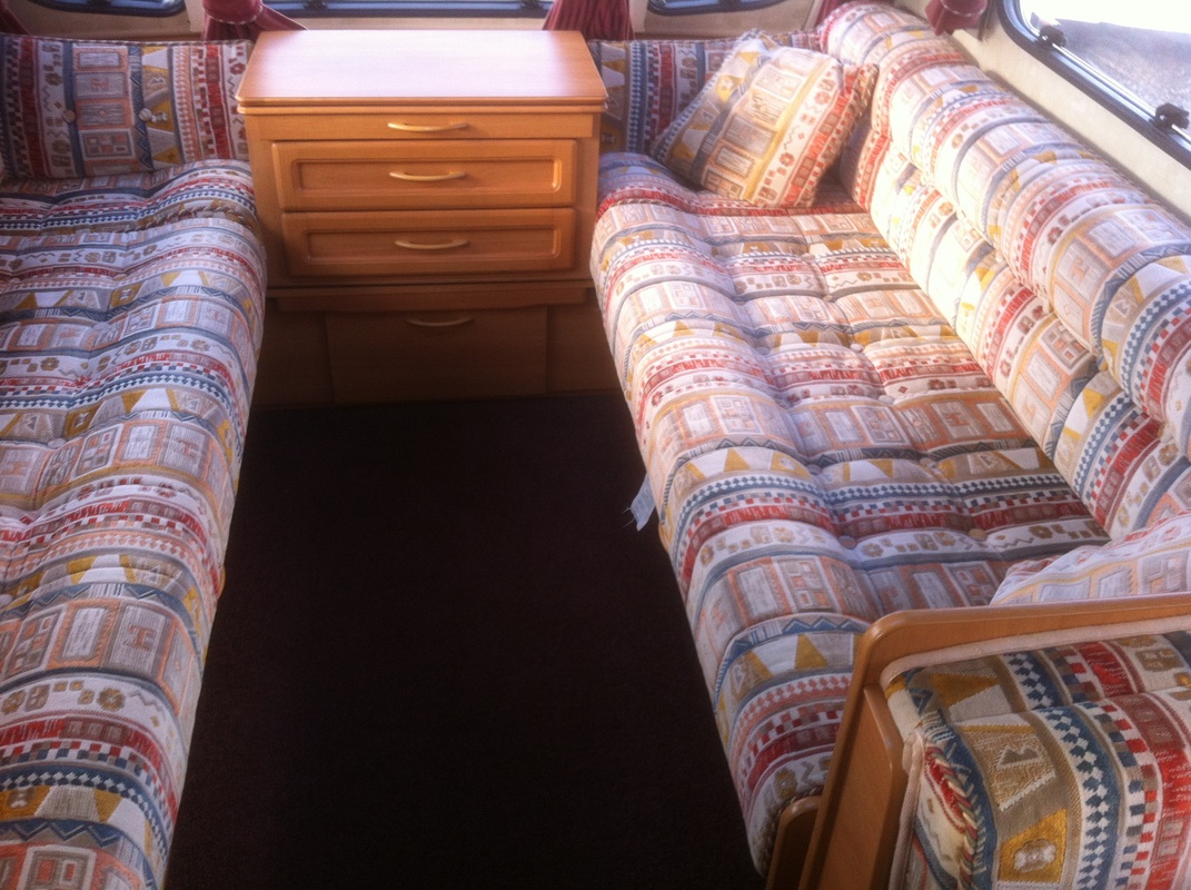 Stripe pattern with red blue white and mustard coloured caravan upholstery